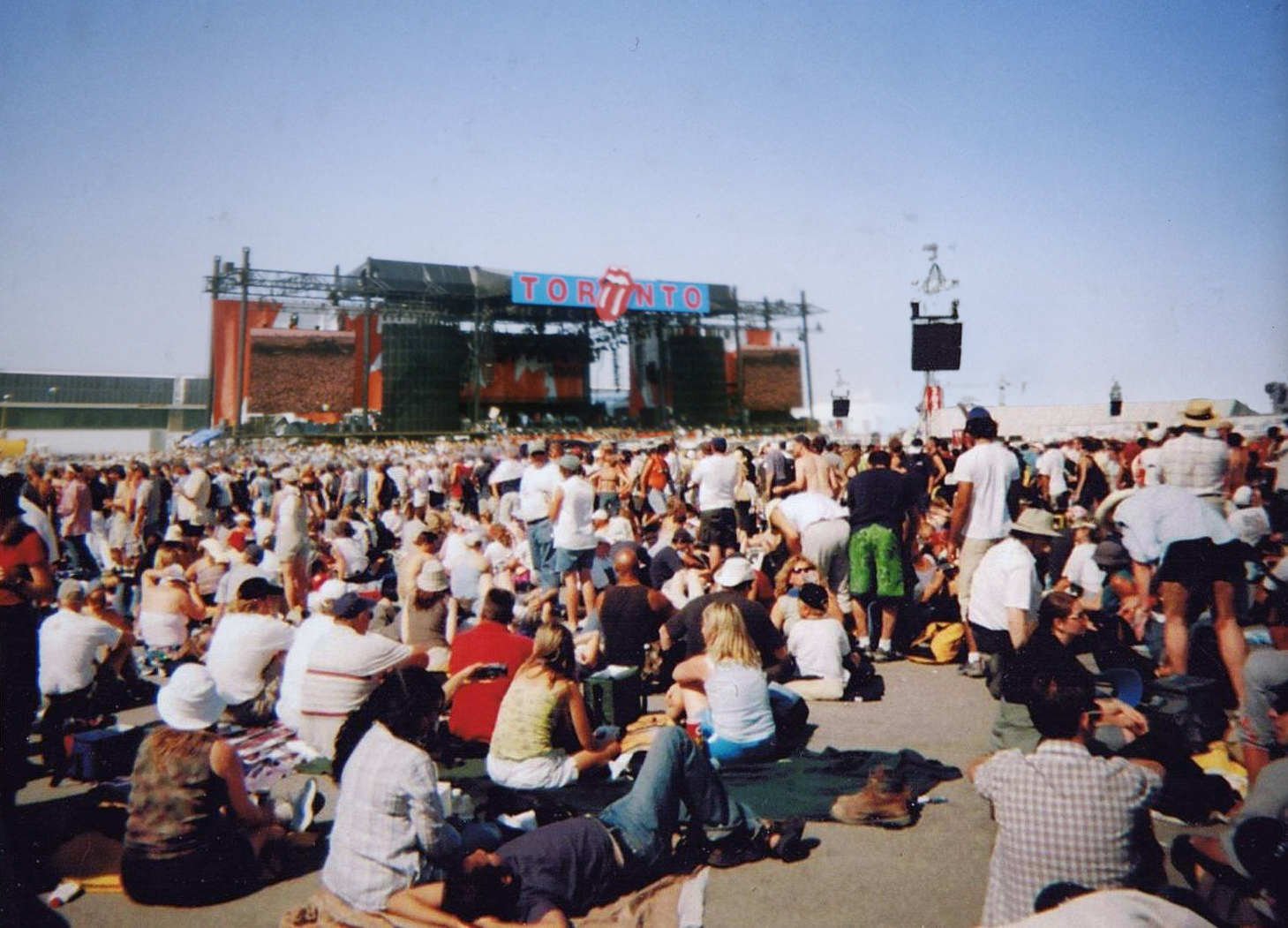 A crowd in front of a large stage.