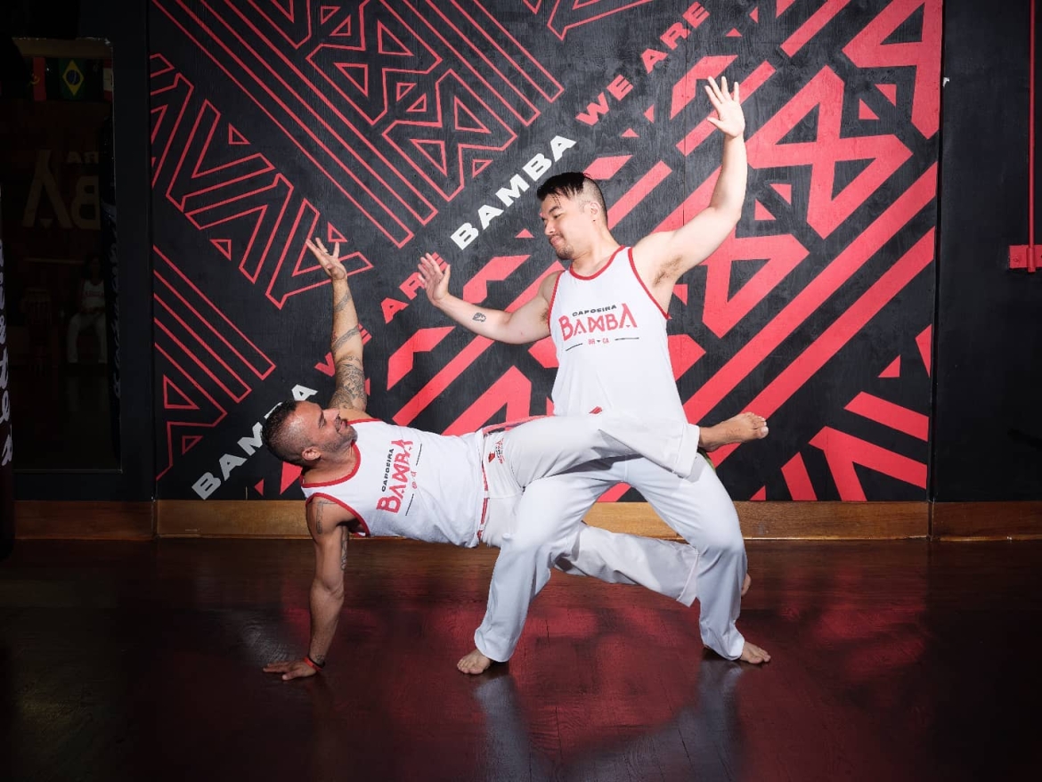 Two Capoeira dancers performing.