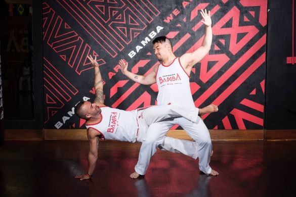 Two Capoeira dancers performing.
