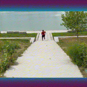 A man running up the stairs by the lake.