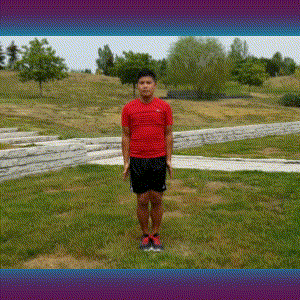 A man doing jumping jacks on the grass.