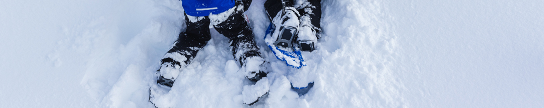 Two kids in snowshoes.
