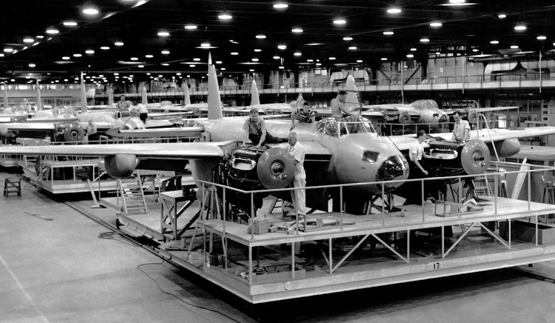 A crew working on an aircraft in a factory.