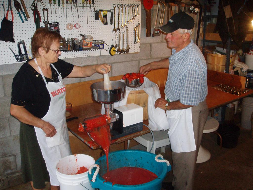 Rosanna stirring a pot in the garage, her second kitchen.