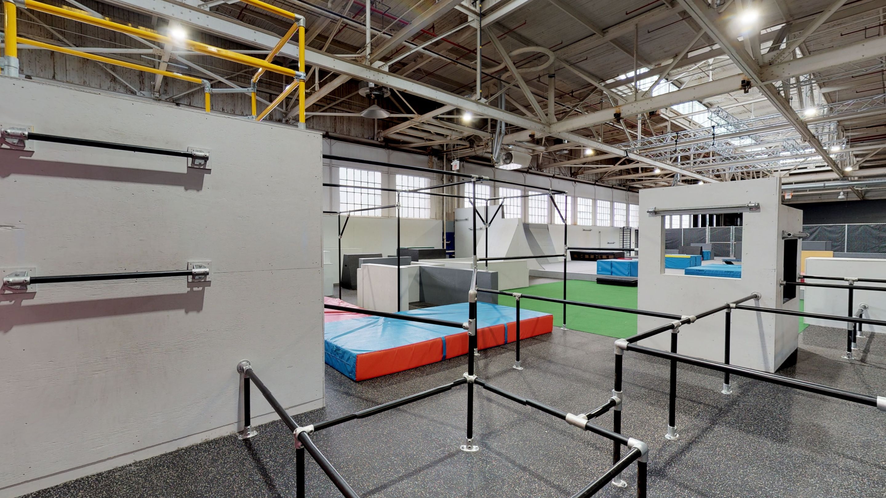 Bars, mats and more at an indoor parkour gym.