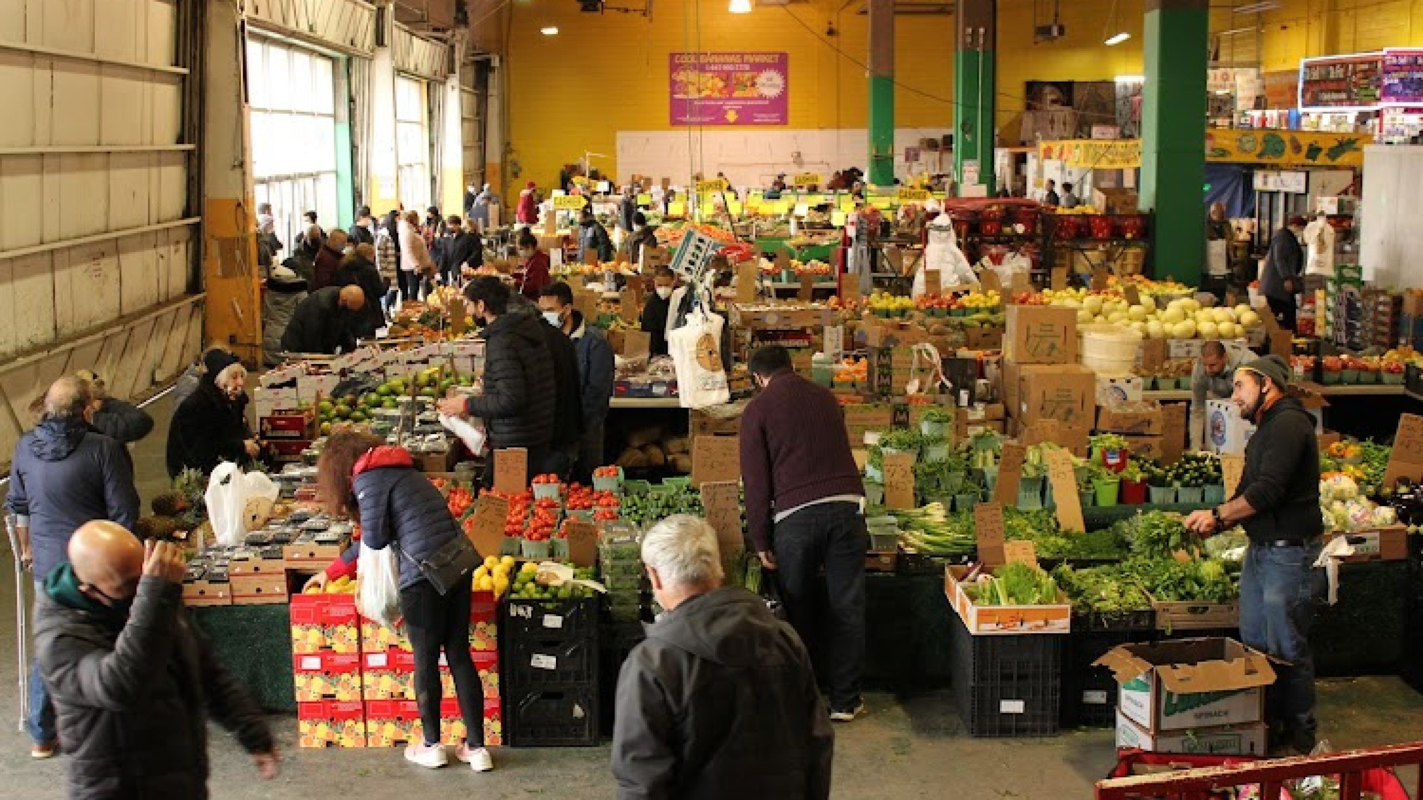 Fruits and veggies for sale in an indoor market. 