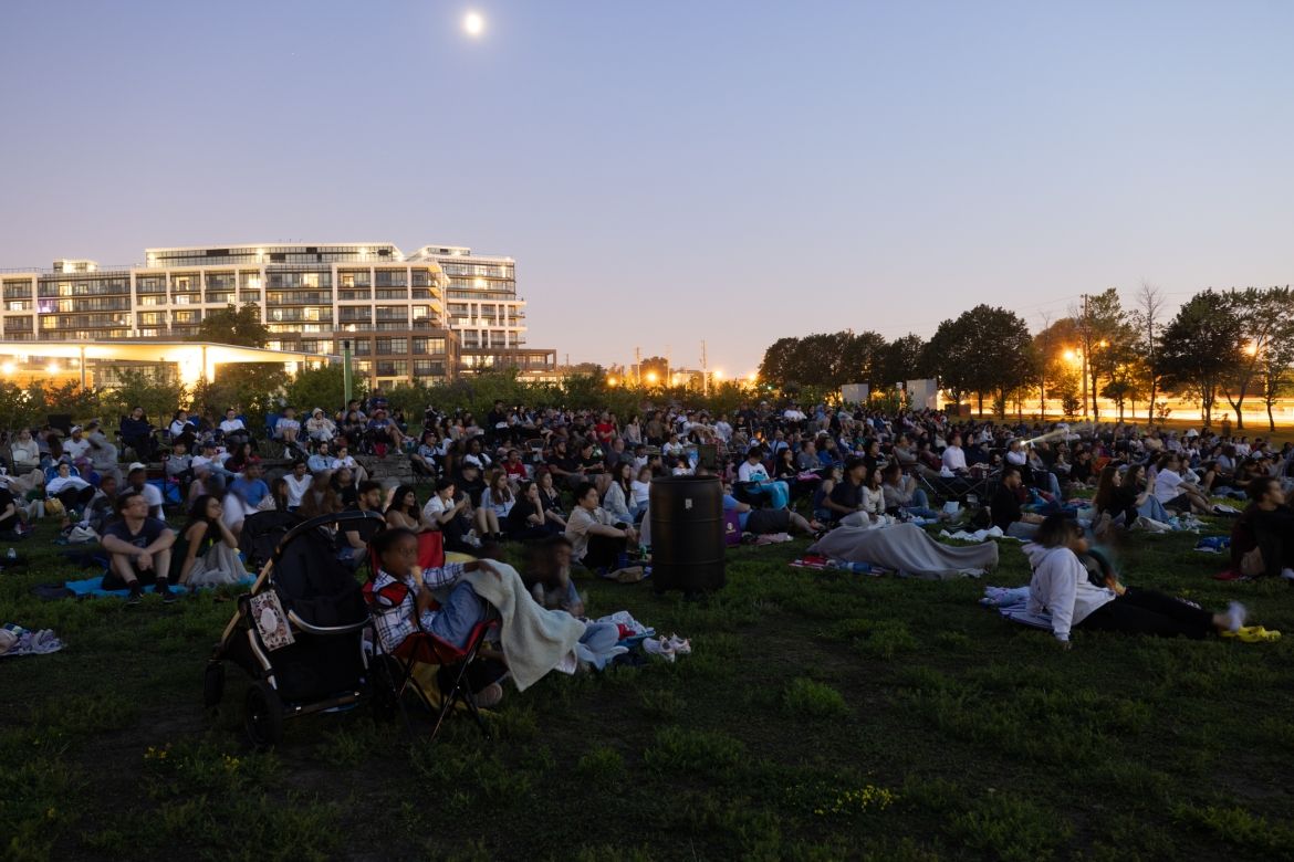people outdoors watching a movie