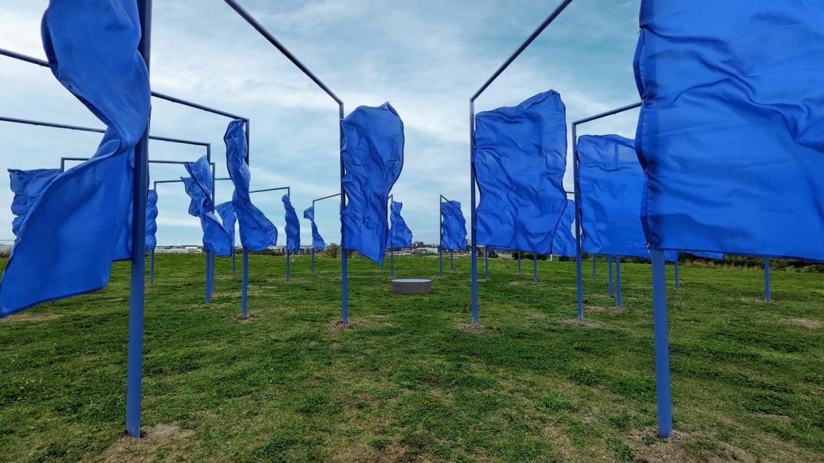 An art installation on top of the Mound featuring large blue flags.