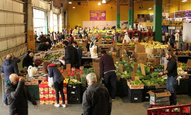 Fruits and veggies for sale in an indoor market.