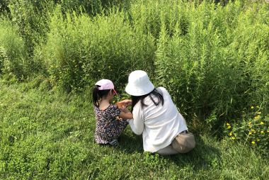 Adult and child in the grass