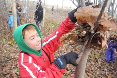 Kid making a nest on a tree