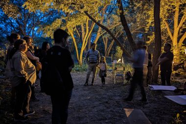 people in the night at a forest