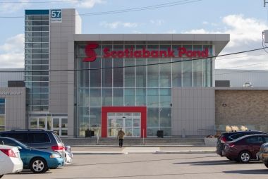 A modern looking building with a sign that says "Scotiabank Pond."