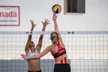Two athletes playing volleyball inside Volleyball Canada's facility.