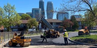 Workers putting in new paving.